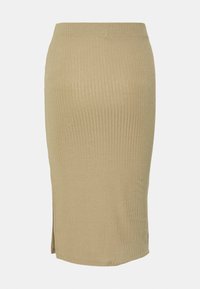 Jupe crayon beige en maille côtelée à taille haute, avec une petite fente sur un côté, présentée sur un fond uni clair.