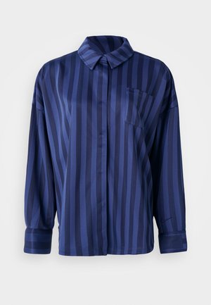 Chemise rayée bleu marine avec col, poche poitrine et manches longues. Fabriquée en tissu lisse et brillant avec une coupe ample.
