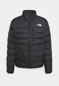 Black padded jacket with stand collar, front zipper, chest zip pocket, and white "The North Face" logo on the left chest.