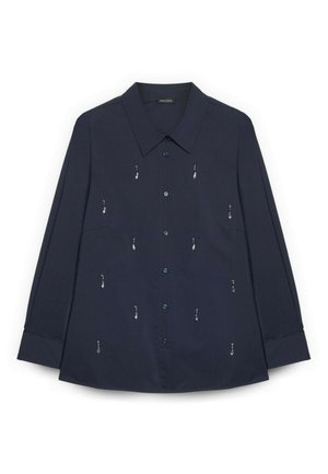 Chemise à manches longues bleu marine avec col pointu et petits ornements argentés en forme de goutte dispersés sur le devant.