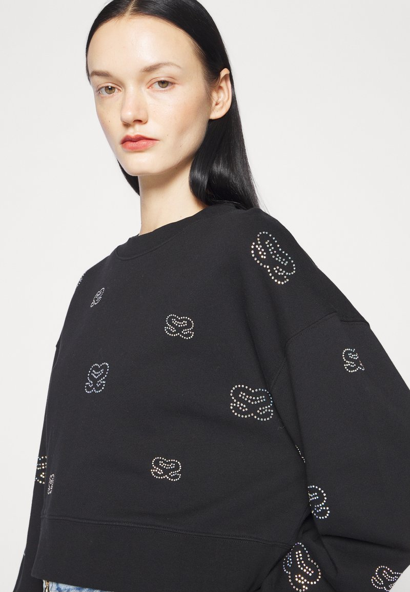 Schwarzer Sweatshirt aus Baumwolle mit lockerer Passform. Verziert mit bunten Elementen, die in einem floralen Muster angeordnet sind. Rundhalsausschnitt.