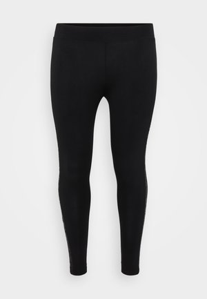 Czarne legginsy o gładkiej fakturze, z wysokim stanem, dopasowanym krojem i koronkowym wykończeniem po bokach. Elastyczny i dobrze dopasowany krój.