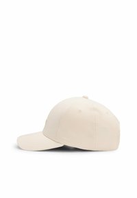 Light beige baseball cap with a curved brim, made from fabric with a smooth texture. Features adjustable strap and subtle logo detail.