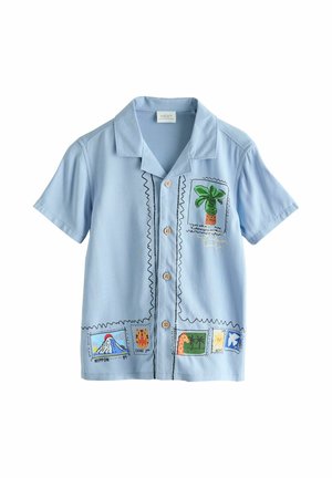 Light blue short-sleeve button-up shirt with colorful travel-themed stamp prints including a palm tree, volcano, and giraffe.