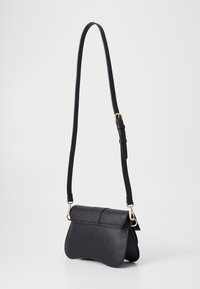 Black leather bag with a curved shape, adjustable strap, and gold hardware accents. Features a flap closure with stitched detailing.