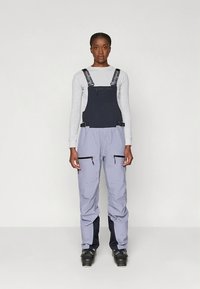 Ski overalls in gray and navy, made of durable fabric. Features adjustable straps, zippered side pockets, and a loose-fit design for comfort.