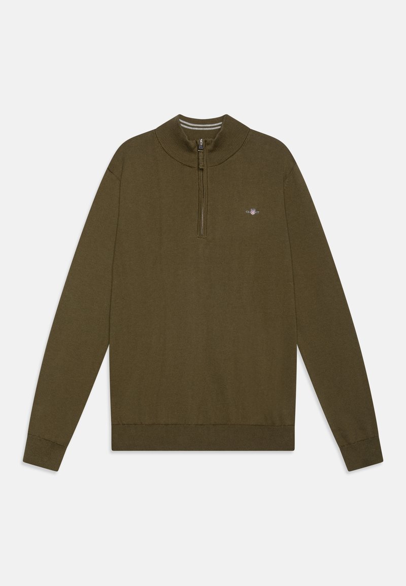 Olīvu zaļš džemperis ar ceturtdaļas rāvējslēdzēju un ribotām aprocēm. Mīksta auduma, minimālistisks dizains, ar mazu zīmola logotipu uz krūtīm.