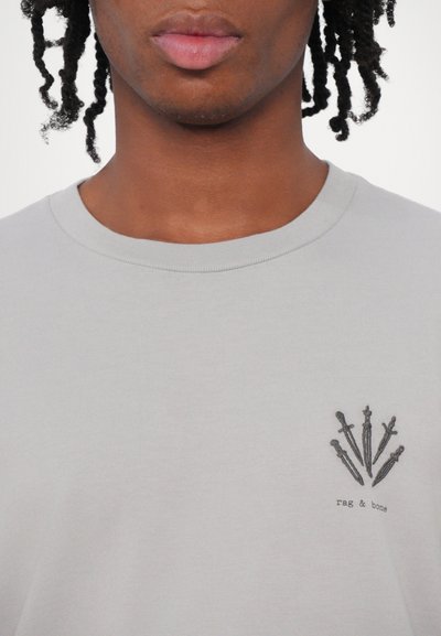 Gray crew neck t-shirt with a subtle texture, featuring a black embroidered design of swords and the brand name "rag & bone" below.