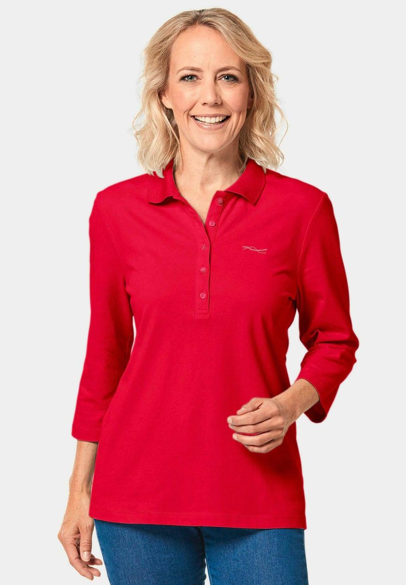 Rode poloshirt met lange mouwen, voorzien van een kraag, knoopsluiting en een klein logo op de linkerborst, gemaakt van zachte stof.