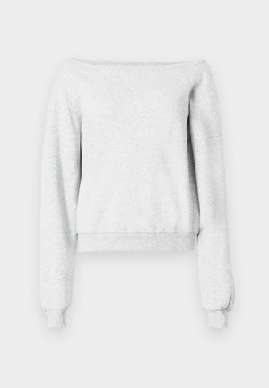 Siva dukserica z nagnjenjem na ramena, dolgimi rokavi in ribastimi manšeti. Narejena je iz mehkega blaga z krajšim robom.