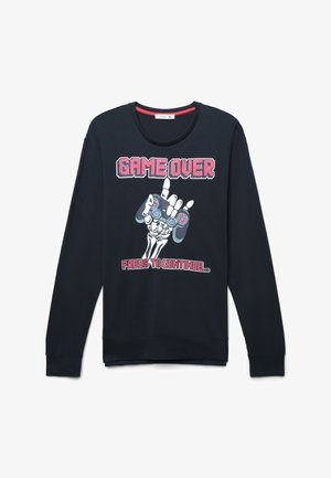 Felpa nera a maniche lunghe con un disegno grafico che presenta una mano di scheletro che tiene un controller di gioco, con la scritta "GAME OVER" e "PRESS TO CONTINUE."