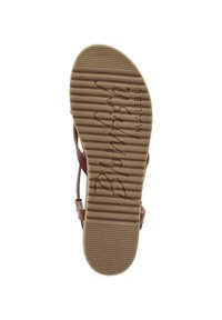 Brown rubber sole with vertical grooves. Features embossed "Blowfish Malibu" logo. Strappy design on upper with adjustable straps.
