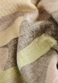 Textilie se soft, tlumenými barvami: béžová, hnědá a zelená. Tkanina má hladký, mírně texturovaný povrch s horizontálními pruhy.