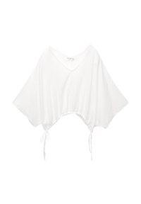 Crop top blanc en tissu texturé, avec un décolleté en V profond, des manches larges et des cordons de serrage ajustables à l'ourlet.