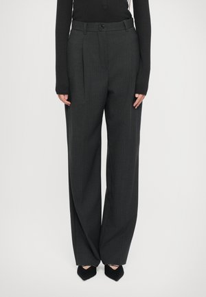 Dark gray pleated trousers with a pinstripe pattern, made of a textured fabric, featuring a button closure and side pockets.