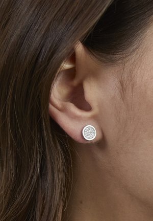 Round stud earrings with a silver-tone frame and a center filled with small, clear crystals. Smooth metal surface, polished finish.