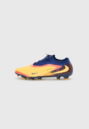 Nike football boot featuring a vibrant yellow upper with a textured surface, navy blue accents, and multicolored detailing on the heel.