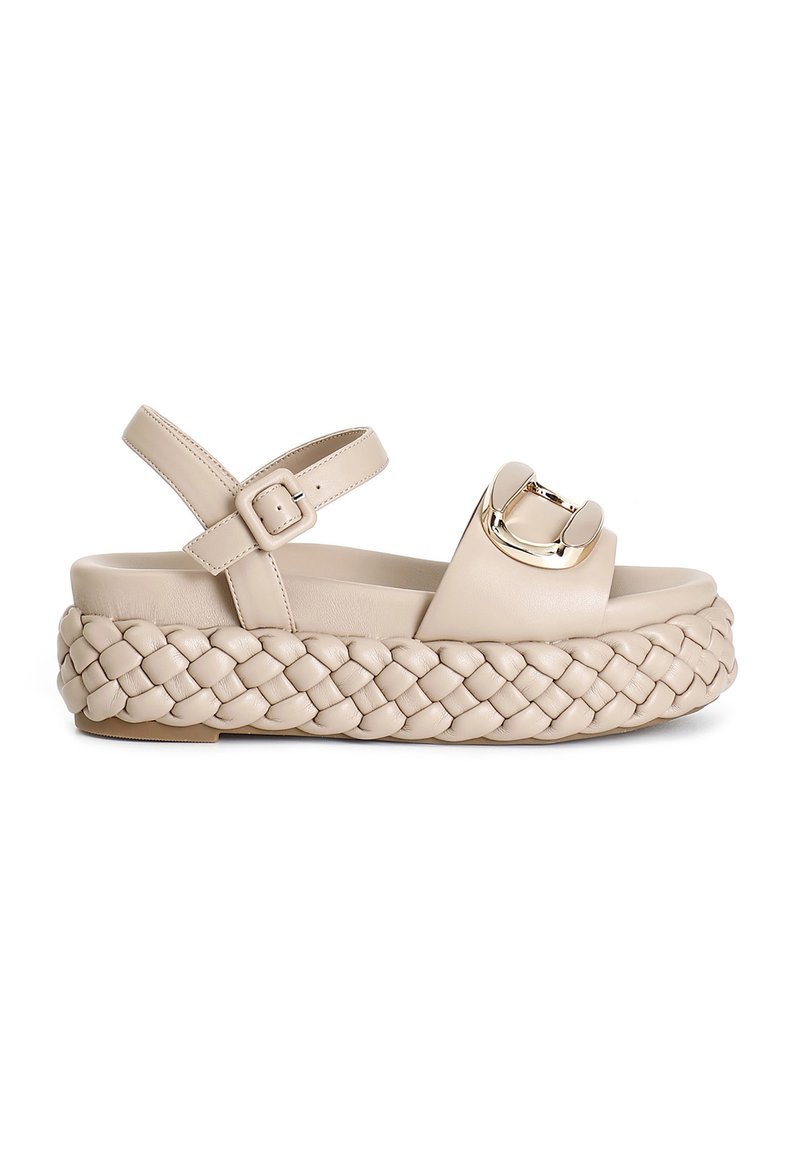 Beige platform sandals with braided leather sole, wide strap and gold-toned buckle accent. Adjustable ankle strap for fit.
