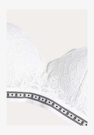 Bralette en dentelle blanche avec motif floral, bords festonnés et une large bande blanche avec des accents noirs et un texte de logo.