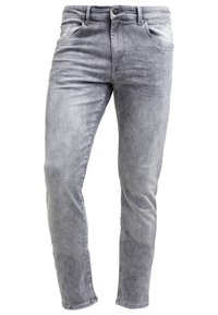 Jean slim gris clair avec bouton à l'avant, fermeture éclair et design cinq poches en tissu denim délavé.