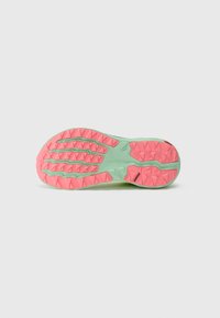 Shoe outsole features a textured design with green and pink colors, triangular lugs for traction, and a smooth heel area.
