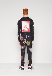 Jordan Pantalones deportivos - black/sail