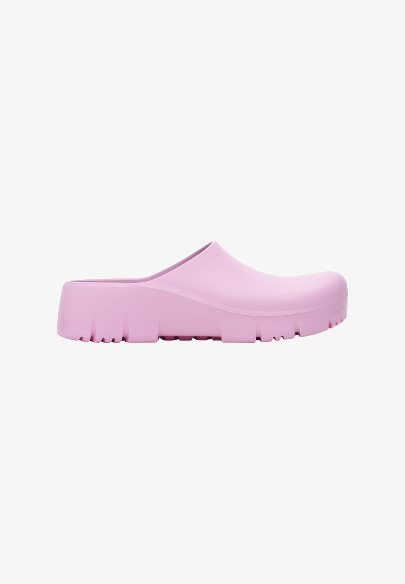 Zoccolo di gomma rosa con superficie liscia, punta arrotondata e suola spessa caratterizzata da un motivo di battistrada testurizzato per una presa migliore.