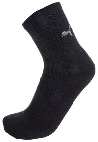 Czarna skarpetka do kostki z prążkowaniem z białym logo Pumy po boku.