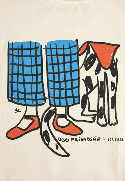 Jambes en pantalon à carreaux bleus et chaussures rouges debout à côté d'un chien tacheté noir et blanc avec un bandana rouge, avec le texte « L'amitié canine est pour toujours. »