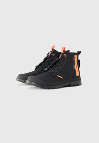 Black high-top boots with orange accents, smooth synthetic material, round toe, lace-up design, and textured rubber sole for grip.