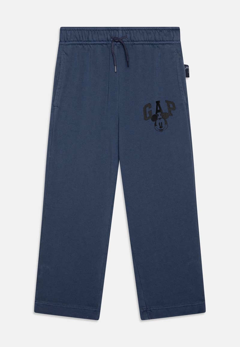Námorníckomodré tepláky vyrobené z bavlneného zmesového materiálu, s elastickým pásom so šnúrkou, bočnými vreckami a čiernym logom "GAP" s kreslenou tvárou.