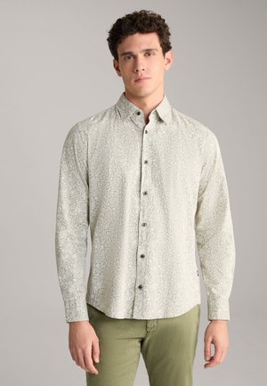 Light green patterned shirt with a button-down collar, long sleeves, and brown buttons. Pairing olive green pants completes the outfit.