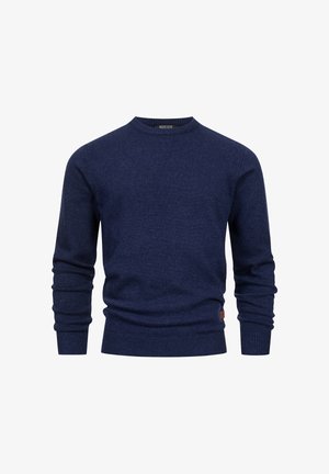 Marineblå strikkegenser med rund hals, ribbestrikkede mansjetter og kant, myk tekstur og subtil logoakcent på den nedre siden.