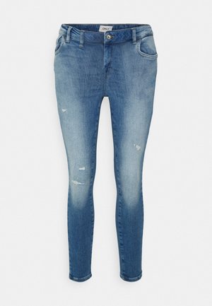 Jeans skinny de denim azul claro com um acabamento desbotado, detalhes desgastados, bolsos frontais e fecho de zip com botão.