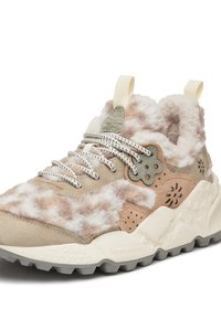 Beige lace-up sneakers feature a plush upper with a light brown and cream mottled pattern. Textured accents and a robust rubber sole are visible.