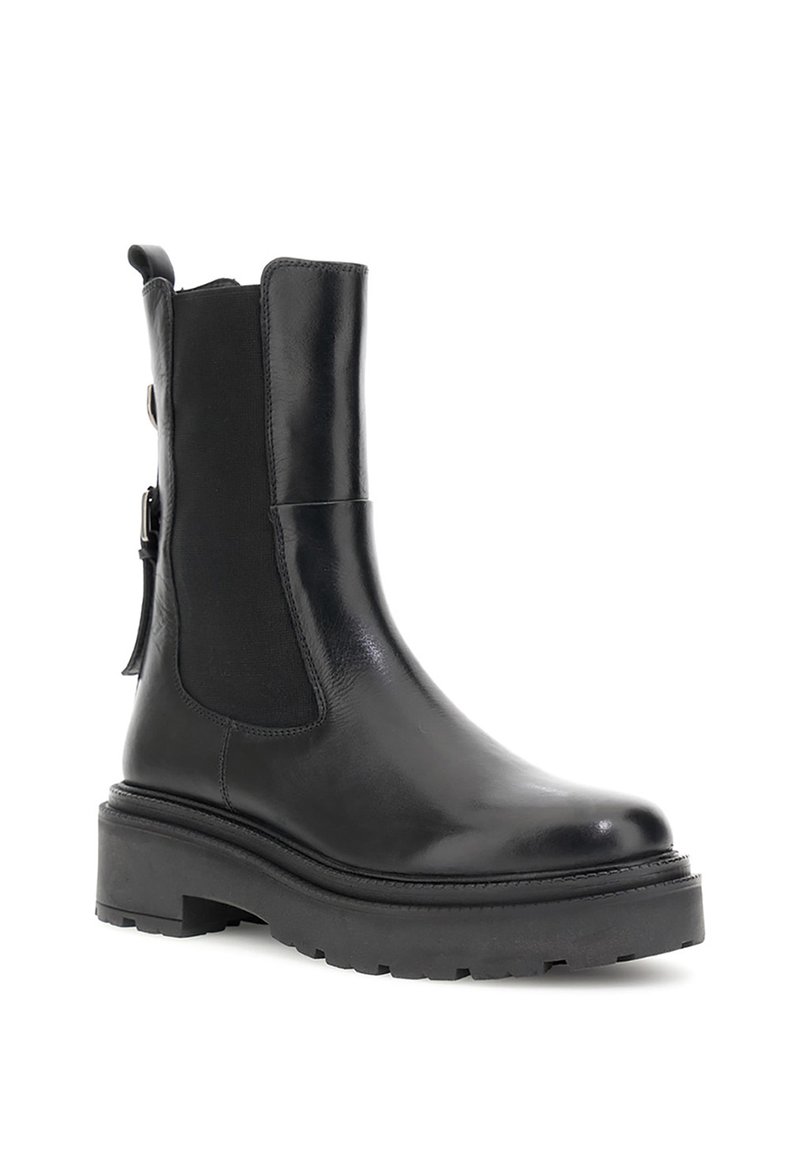 Stivali alla caviglia neri in pelle liscia con pannelli laterali elasticizzati, suola in gomma spessa e dettagli a contrasto lungo la zip.