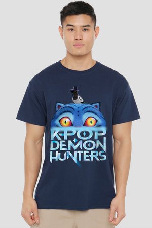 Young man wearing a navy blue T-shirt with bright yellow cat eyes and a bird with a hat, text says "K-POP DEMON HUNTERS."