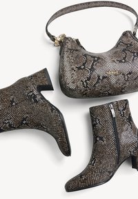 Brown and black snake-print ankle boots with a low, chunky heel, alongside a matching handbag with a textured finish and gold hardware accents.