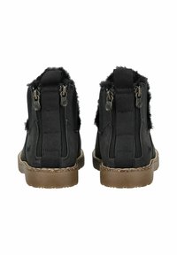 Black high-top boots with dual side zippers, textured fur accents, and a tan rubber sole. Features padded collar and stitched detailing.