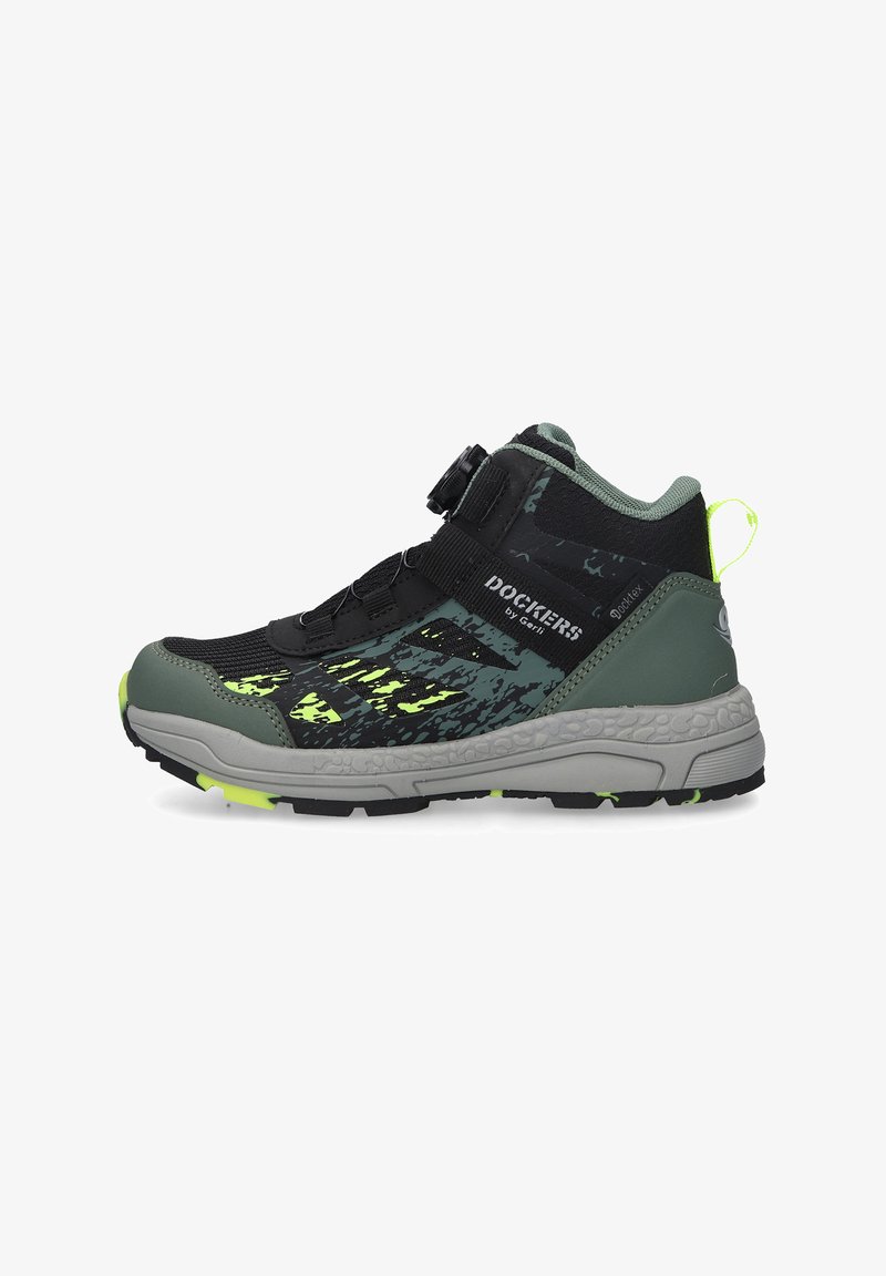 Black and green hiking shoes with a textured upper, featuring a secure strap, logo detail, and a rugged gray sole with yellow accents.