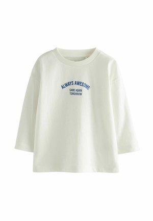 Witte katoenen sweatshirt met een ronde halslijn en driekwart mouwen, met blauwe tekst: "ALTIJD FANTASTISCH DEZELFDE VOLGENDE DAG."