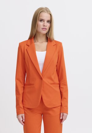 Orange fitted blazer with a single button closure, notched lapels, and two front pockets, paired with matching trousers.
