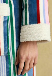 Fleece robe with bold, multicolored stripes in pink, green, blue, and red. Features soft, textured white cuffs and a smooth body.