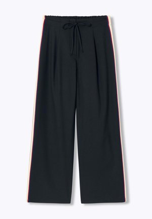 Pantalon large noir avec taille élastique et cordon de serrage, équipé de bandes latérales blanches et rouges.