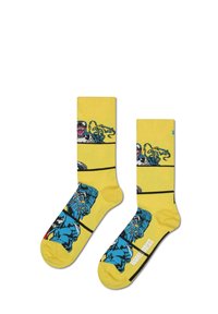 Chaussettes jaunes présentant des personnages et des graphismes de style bande dessinée en bleu, blanc et noir, avec un design à motifs et des accents noirs.