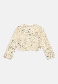 Κρέμ  κοντό τοπ με μακριά μανίκια, διακοσμημένο με περίπλοκο δαντέλα, παγιέτες και χάντρες, με ριχτή γραμμή και διακριτά λουλουδάτα μοτίβα.