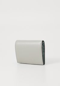 Light gray leather wallet with a textured finish, fold-over design, and contrasting green interior. Compact shape with stitched detailing.
