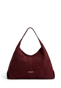 Burgundy suede hobo bag with a single top handle, smooth texture, minimal stitching, and a gold logo plaque on the front.
