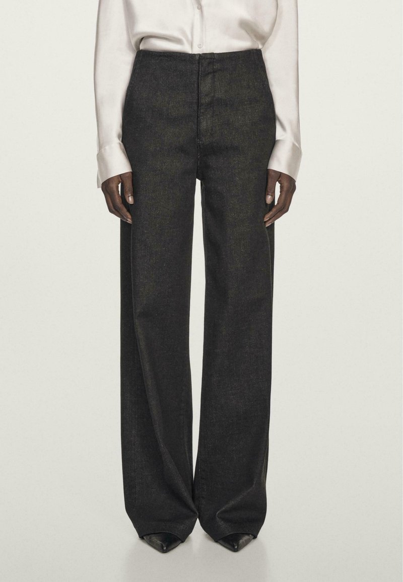 Sorte højtaljede denimbukser med vidde. Stof har en glat tekstur, med minimal syning og en subtil glans.