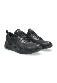 Black athletic shoes made of mesh and synthetic material, featuring a textured surface, structured design, and a cushioned sole.